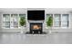 Modern stone fireplace as a focal point in a sunroom at 1017 Vino Drive Dr, Cary, NC 27607