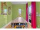 Bright dining area with a long wooden table and green walls at 222 Saint Marys St, Raleigh, NC 27605