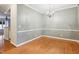 Bright dining room featuring hardwood floors and elegant chandelier at 661 Boone Station Dr # 4, Burlington, NC 27215