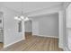 Dining room with hardwood floors, chandelier, and access to kitchen at 142 Brentfield Loop, Morrisville, NC 27560