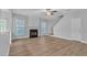 Living room with hardwood floors, fireplace, and ceiling fan at 142 Brentfield Loop, Morrisville, NC 27560