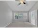 Primary bedroom with vaulted ceiling, three windows, and ceiling fan at 142 Brentfield Loop, Morrisville, NC 27560