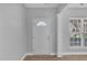 Front entry with white door, wood flooring and adjacent window at 142 Brentfield Loop, Morrisville, NC 27560