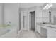 Primary bathroom with a bathtub, double vanity, and granite countertop at 142 Brentfield Loop, Morrisville, NC 27560