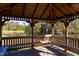 Wooden gazebo with benches overlooking a pond at 142 Brentfield Loop, Morrisville, NC 27560