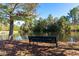 Serene community pond with a peaceful bench at 142 Brentfield Loop, Morrisville, NC 27560