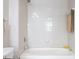 Clean bathroom with a bathtub and off-white tiled walls at 222 Glenwood # 602, Raleigh, NC 27603