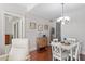 Bright dining area with white table and chairs, hardwood floors at 222 Glenwood # 602, Raleigh, NC 27603