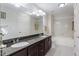 Double vanity bathroom with granite countertop and large mirror at 222 Glenwood # 602, Raleigh, NC 27603