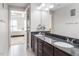 Double vanity bathroom with granite countertop and view of bedroom at 222 Glenwood # 602, Raleigh, NC 27603