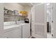 Well-lit laundry room with washer, dryer, and shelving at 222 Glenwood # 602, Raleigh, NC 27603