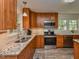 Modern kitchen with granite countertops and stainless steel appliances at 178 Paceville Rd, Selma, NC 27576
