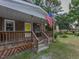 Inviting front porch with rocking chairs and American flag at 178 Paceville Rd, Selma, NC 27576