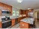 Large kitchen island with granite countertop and seating for three at 178 Paceville Rd, Selma, NC 27576