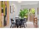 Bright dining area with glass table, black chairs, and sliding glass door at 3738 Yorktown Pl, Raleigh, NC 27609
