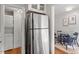 View of kitchen, stainless steel refrigerator, and adjacent dining area at 3738 Yorktown Pl, Raleigh, NC 27609