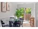 Dining area with glass table, black chairs, and view of backyard at 3738 Yorktown Pl, Raleigh, NC 27609