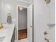 Bathroom with a double vanity, subway tile shower, and gold fixtures at 3738 Yorktown Pl, Raleigh, NC 27609