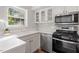 Bright kitchen features stainless steel appliances and white shaker cabinets at 3738 Yorktown Pl, Raleigh, NC 27609