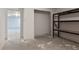 Unfinished basement with shelving unit and open space at 415 River Bluff Dr, Dunn, NC 28334