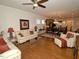 Open concept living room with hardwood floors, comfortable seating, and a view of the kitchen at 528 Turnstone Dr, Durham, NC 27703