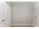 Convenient laundry room with built-in shelving and tile flooring at 7827 Cape Charles Dr, Raleigh, NC 27617