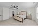 Main bedroom with plush bed, ceiling fan, and ensuite bathroom at 8901 Brook Trout Ln, Willow Springs, NC 27592