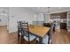 Bright dining room with wood table and chairs, adjacent to kitchen at 8901 Brook Trout Ln, Willow Springs, NC 27592