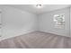 Cozy bedroom with carpeted floor and a large window at 2840 Huxley Way, Apex, NC 27502