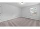 Bright bedroom with carpeted floors and two windows at 2864 Huxley Way, Apex, NC 27502
