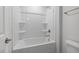 Clean bathroom with a tub, shower, and shelving at 2884 Huxley Way, Apex, NC 27502