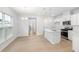 Open concept dining area with hardwood floors and views into the kitchen and hallway at 2884 Huxley Way, Apex, NC 27502