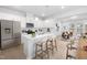 Modern kitchen features island with seating, stainless steel appliances, and ample cabinet space at 2884 Huxley Way, Apex, NC 27502