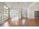 Living room with hardwood floors, sunroom access, and view of front entry at 4720 Ivy Crest Ct, Raleigh, NC 27604