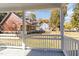 View from the porch, showcasing a fenced backyard and houses at 619 N Mebane St, Burlington, NC 27217