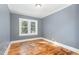 Well-lit bedroom featuring hardwood floors and a window at 619 N Mebane St, Burlington, NC 27217
