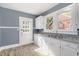 White kitchen cabinets, granite countertops, and a back door at 619 N Mebane St, Burlington, NC 27217