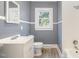 Clean bathroom with white vanity, toilet and bathtub at 619 N Mebane St, Burlington, NC 27217