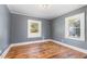 Bedroom with hardwood floors, gray walls, and two windows at 619 N Mebane St, Burlington, NC 27217