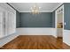 Formal dining room with hardwood floors, chandelier, and wainscoting at 909 Swan Rd, Nashville, NC 27856