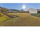 Large backyard with expansive green space and detached workshop at 522 Spruce Meadows Ln, Willow Springs, NC 27592