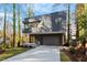 Stylish home with dark gray exterior and a tree-lined street at 1208 Wimbleton Dr, Raleigh, NC 27609