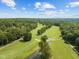 Aerial view of a golf course with lush greens and ponds at 138 Ottawa Dr, Louisburg, NC 27549