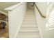 Carpeted staircase with wooden handrail at 4114 Sykes St, Cary, NC 27519