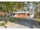 Charming brick ranch home with gravel driveway and mature trees at 6650 Cokesbury Rd, Fuquay Varina, NC 27526