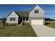 Two-story home with gray siding and stone accents at 11376 International Dr, Middlesex, NC 27557