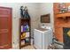 Laundry area with washer, dryer, and shelving unit at 1717 Martin Luther King Dr, Rocky Mount, NC 27801