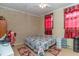 Bedroom with queen bed and brick accent wall at 1717 Martin Luther King Dr, Rocky Mount, NC 27801