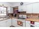 Bright kitchen with white cabinets, tile countertops, and modern appliances at 1717 Martin Luther King Dr, Rocky Mount, NC 27801