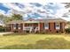 Brick ranch house with a spacious yard and a welcoming front porch at 1717 Martin Luther King Dr, Rocky Mount, NC 27801